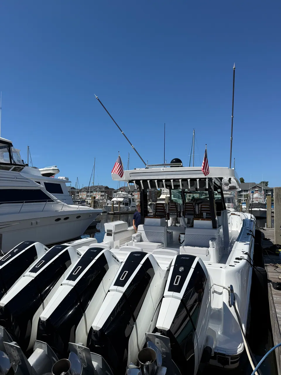 Stern of a center console with five outboards at a marina