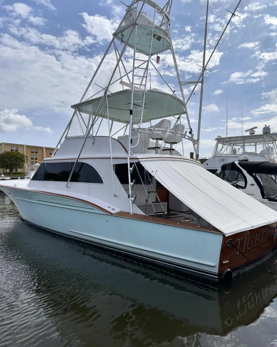 Sportfishing boat with a tall tower moored at a marina