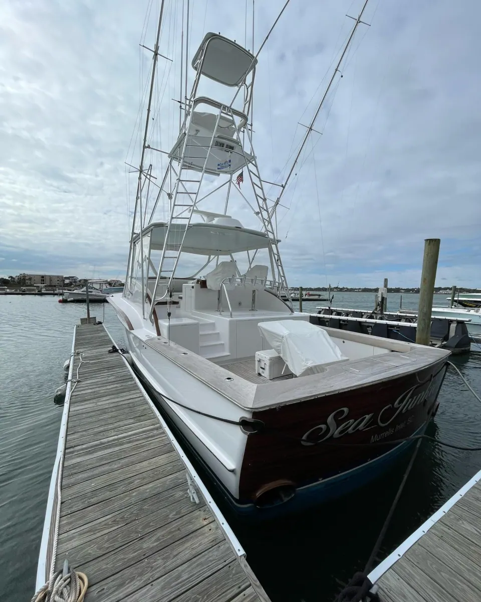 Sportfishing boat alongside a wooden dock